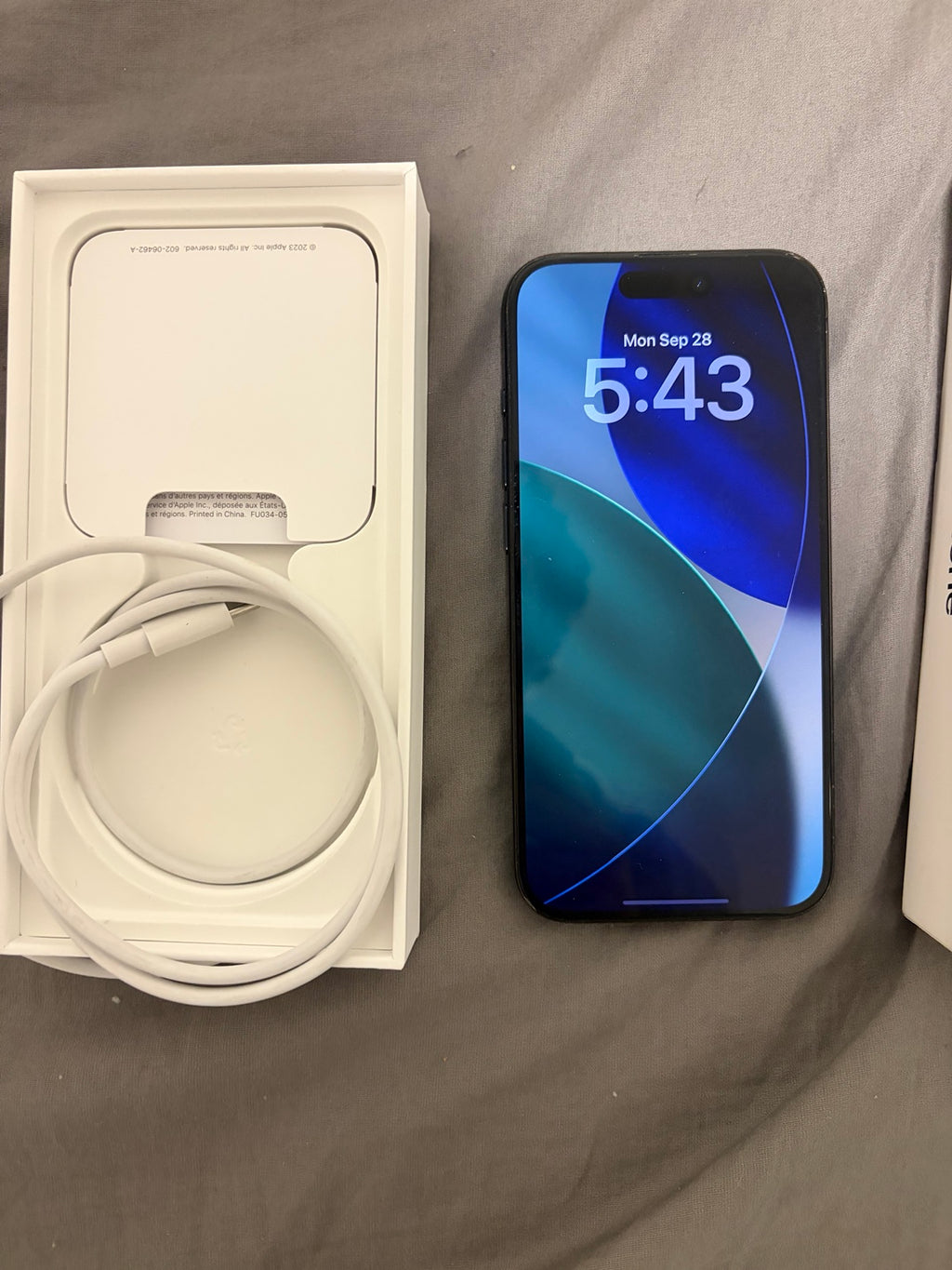 iPhone 15 Pro front with box and USB-C cable